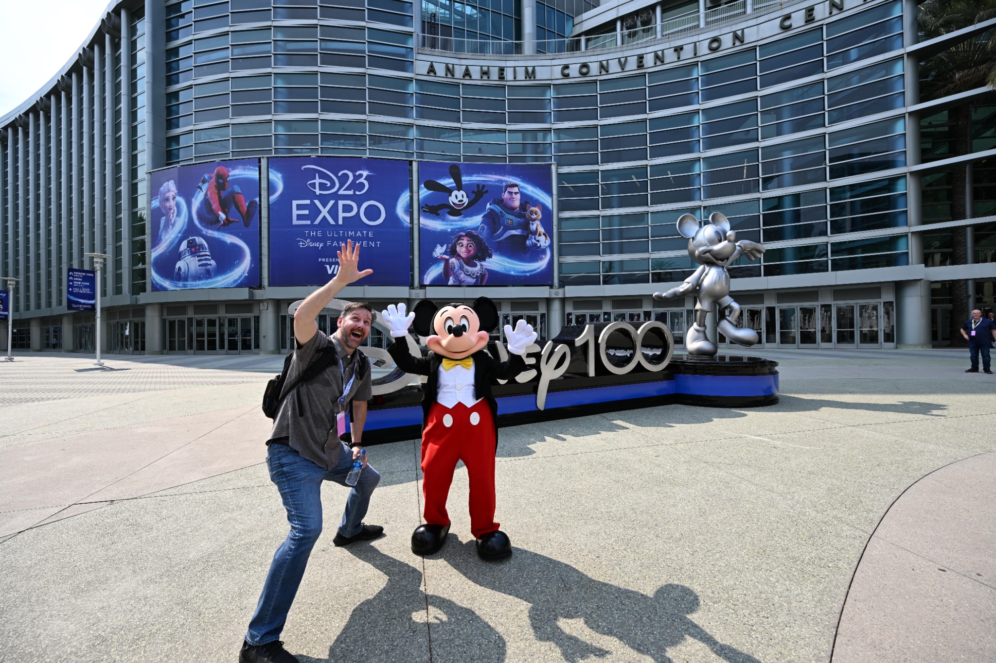 David Acuff and Mickey Mouse waving outside the Anaheim Convention Center at D23 Expo